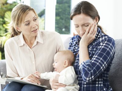 Health Visitor With New Mother Suffering With Depression